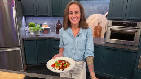 Chef Alyssa Frisby holding peach and tomato salad on Good Morning Arkansas.