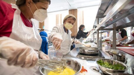 close up of nurses cooking in the Culinary Medicine kitchen