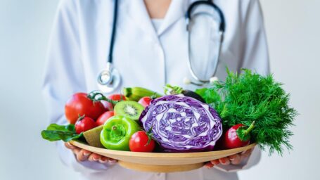 Close up of Doctor holding fresh fruit and vegetable, Healthy diet