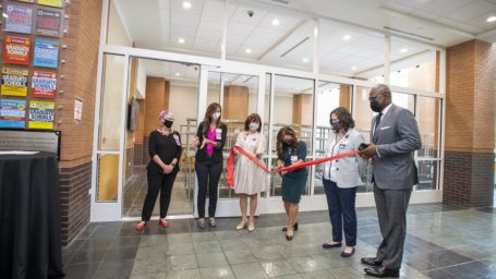 group cuts the ribbon on the new teaching kitchen